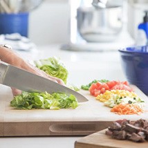 Woman cutting lettuce on a cutting board
