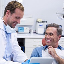 Dentist showing a patient his good oral exam results