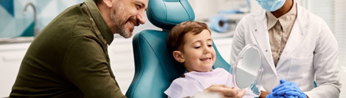 Father and son admiring the little guy’s freshly cleaned teeth