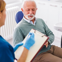 Senior adult reviewing his checkup results with his dentist