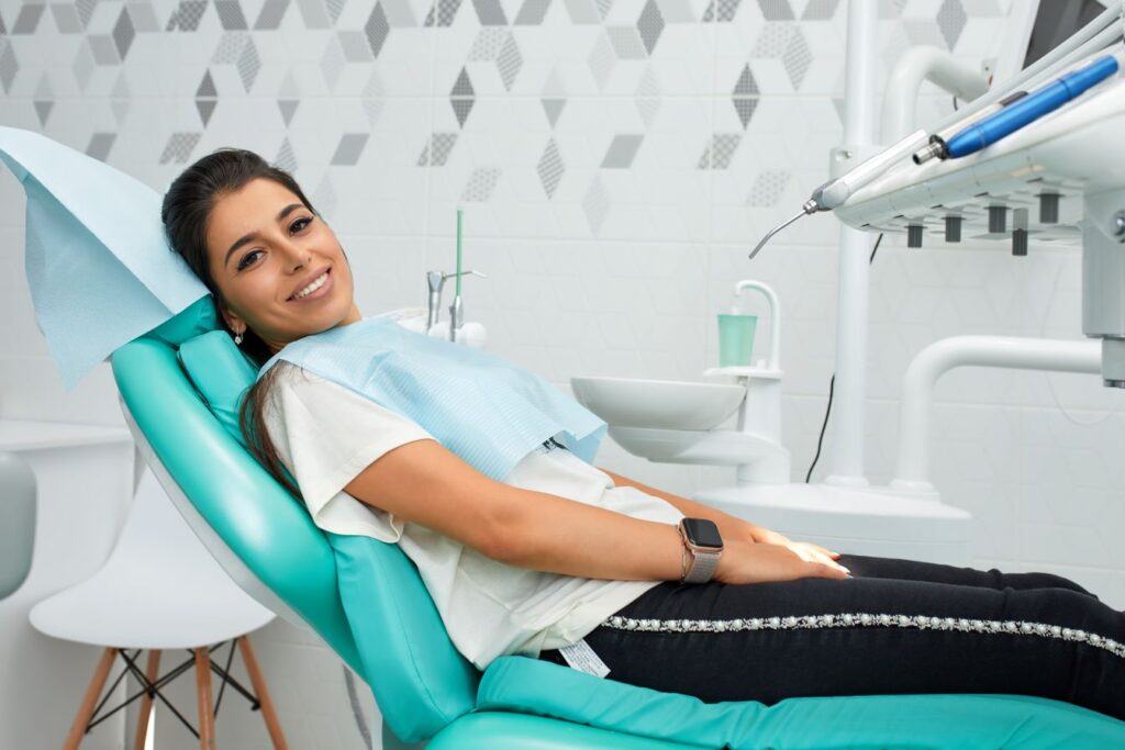 A woman sitting in a dental chair.